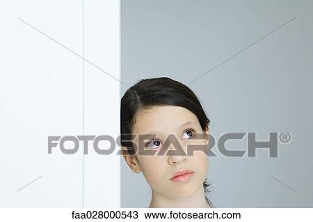 Preteen girl leaning against wall, looking up View Large Photo Image Stock Image - Preteen girl leaning against wall, looking up. Fotosearch