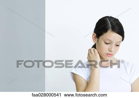 Preteen girl looking down, portrait View Large Photo Image Stock Image - Preteen girl looking down, portrait. Fotosearch