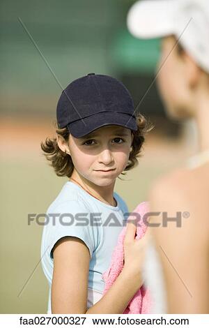 Preteen girl wearing cap, holding towel, looking at camera View Large Photo Image Stock Photo - Preteen girl wearing cap, holding towel, looking at camera. Fotosearch