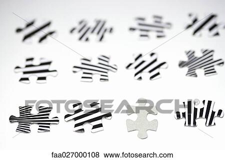 Puzzle pieces lined up, one blank, the others striped, close-up View Large Photo Image Stock Photo - Puzzle pieces lined up, one blank, the others striped, close-up. Fotosearch