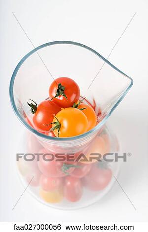 Red and yellow cherry tomatoes in pitcher, high angle view View Large Photo Image Stock Photograph - Red and yellow cherry tomatoes in pitcher, high angle view. Fotosearch