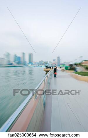 Riverside walkway, blurred motion View Large Photo Image Picture - Riverside walkway, blurred motion. Fotosearch