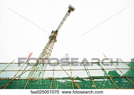 Scaffolding and crane, low angle view View Large Photo Image Stock Image - Scaffolding and crane, low angle view. Fotosearch