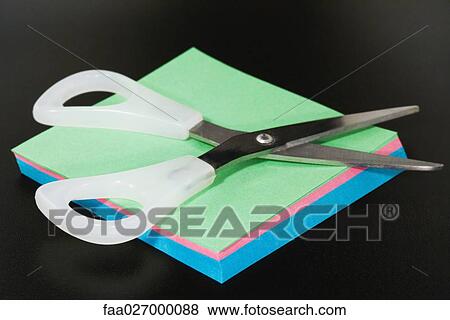 Scissors resting on blank paper, close-up View Large Photo Image Stock Photo - Scissors resting on blank paper, close-up. Fotosearch