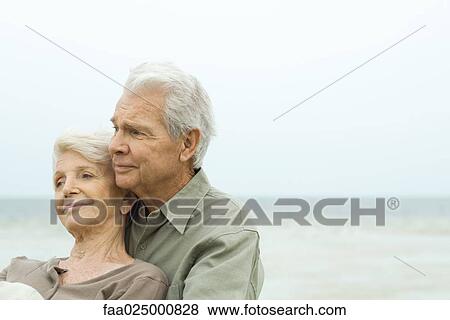 Senior couple cheek to cheek outdoors, smiling and looking away, close-up View Large Photo Image Stock Photo - Senior couple cheek to cheek outdoors, smiling and looking away, close-up. Fotosearch