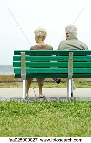 Senior couple sitting on bench together, rear view View Large Photo Image Stock Photo - Senior couple sitting on bench together, rear view. Fotosearch