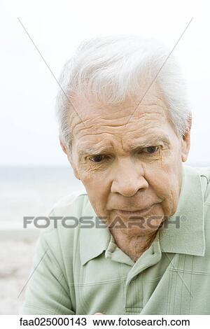 Senior man looking down, furrowing brow, close-up View Large Photo Image Stock Image - Senior man looking down, furrowing brow, close-up. Fotosearch