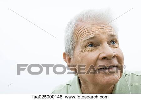 Senior man looking up, smiling, portrait View Large Photo Image Stock Photograph - Senior man looking up, smiling, portrait. Fotosearch