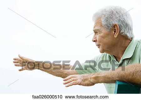 Senior man sitting with arms outstretched, looking away, side view View Large Photo Image Stock Image - Senior man sitting with arms outstretched, looking away, side view. Fotosearch