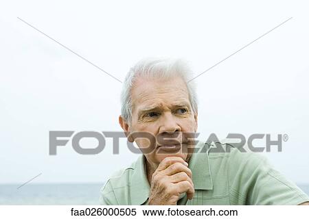 Senior man with hand under chin, furrowing brow, looking away View Large Photo Image Stock Photography - Senior man with hand under chin, furrowing brow, looking away. Fotosearch