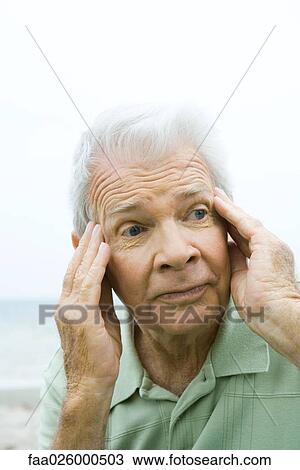 Senior man with hands on temples, looking away, close-up View Large Photo Image Stock Image - Senior man with hands on temples, looking away, close-up. Fotosearch