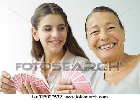 Senior woman and granddaughter playing cards View Large Photo Image Stock Image - Senior woman and granddaughter playing cards. Fotosearch