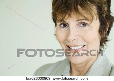 Senior woman smiling at camera, close-up, portrait View Large Photo Image Stock Photo - Senior woman smiling at camera, close-up, portrait. Fotosearch
