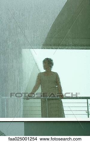 Silhouette of woman looking through window in rain View Large Photo Image Picture - Silhouette of woman looking through window in rain. Fotosearch