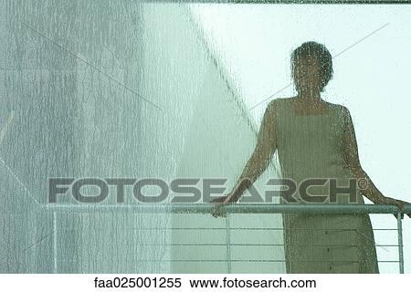 Silhouette of woman looking through window in rain View Large Photo Image Stock Photography - Silhouette of woman looking through window in rain. Fotosearch