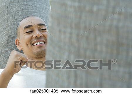 smiling, tree trunk, fist, winner, toothy smile, mid adult men View Large Photo Image Stock Photography - smiling, tree trunk, fist, winner, toothy smile, mid adult men. Fotosearch