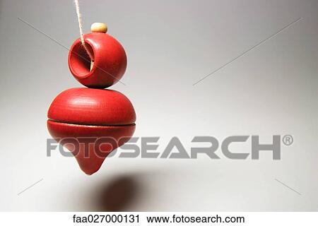 Spinning top hanging on string, close-up View Large Photo Image Stock Image - Spinning top hanging on string, close-up. Fotosearch