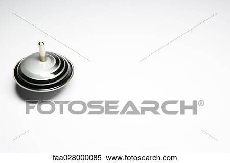 Spinning toy top, close-up View Large Photo Image Stock Photography - Spinning toy top, close-up. Fotosearch