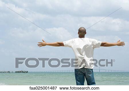 standing, arms out, arms outstretched, water's edge, mid adult men, freedom View Large Photo Image Stock Photo - standing, arms out, arms outstretched, water's edge, mid adult men, freedom. Fotosearch