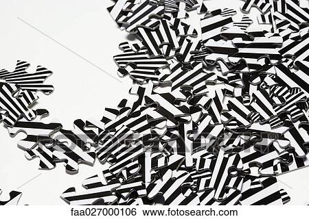 Striped jigsaw puzzle pieces in a pile, close-up View Large Photo Image Stock Photograph - Striped jigsaw puzzle pieces in a pile, close-up. Fotosearch