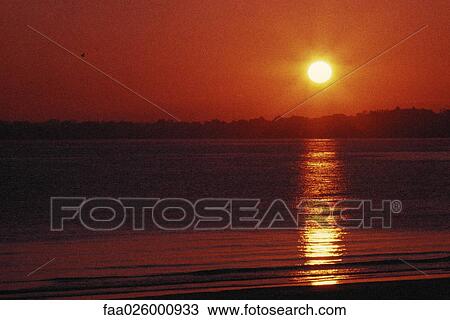 Sunset over water View Large Photo Image Stock Image - Sunset over water. Fotosearch