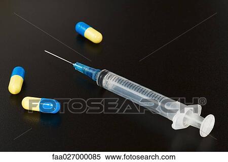 Syringe and capsules, close-up View Large Photo Image Stock Photography - Syringe and capsules, close-up. Fotosearch