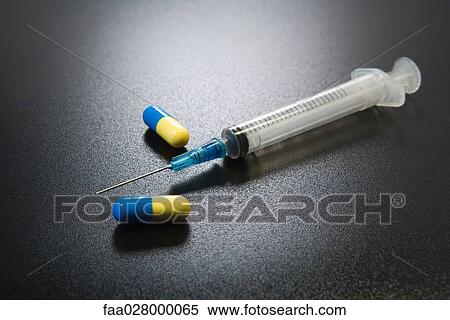 Syringe and drug capsules, close-up View Large Photo Image Stock Photography - Syringe and drug capsules, close-up. Fotosearch