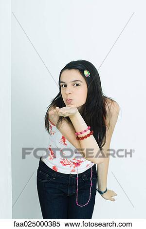 Teen girl blowing a kiss at camera, portrait View Large Photo Image Stock Photography - Teen girl blowing a kiss at camera, portrait. Fotosearch