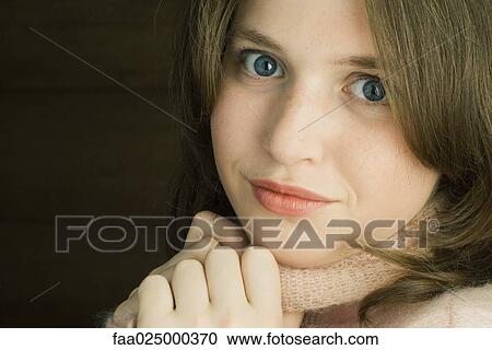 Teen girl holding sweater neck, looking at camera, portrait View Large Photo Image Stock Image - Teen girl holding sweater neck, looking at camera, portrait. Fotosearch