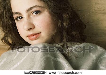Teen girl, pulling up blanket under chin, portrait View Large Photo Image Picture - Teen girl, pulling up blanket under chin, portrait. Fotosearch