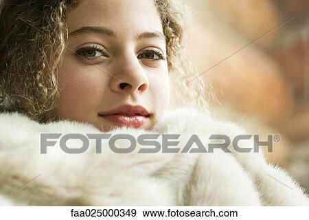 Teen girl under soft blanket, smiling at camera, close-up View Large Photo Image Stock Photo - Teen girl under soft blanket, smiling at camera, close-up. Fotosearch