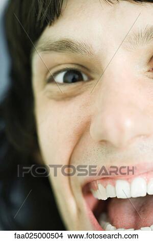 Teenage boy smiling at camera, extreme close-up View Large Photo Image Picture - Teenage boy smiling at camera, extreme close-up. Fotosearch