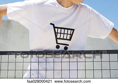 Teenage boy wearing tee-shirt printed with shopping cart, cropped view View Large Photo Image Stock Image - Teenage boy wearing tee-shirt printed with shopping cart, cropped view. Fotosearch