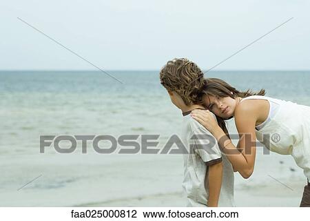 Teenage girl at the beach, leaning head against brother, looking at camera View Large Photo Image Stock Image - Teenage girl at the beach, leaning head against brother, looking at camera. Fotosearch