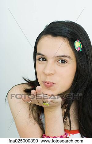 Teenage girl blowing a kiss at camera, portrait View Large Photo Image Stock Image - Teenage girl blowing a kiss at camera, portrait. Fotosearch