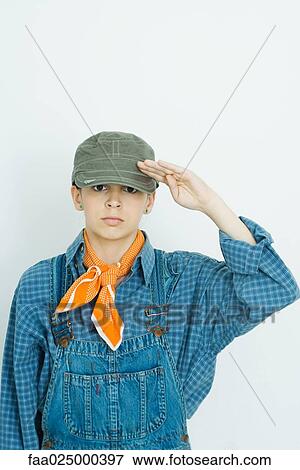 Teenage girl dressed in overalls and hat, saluting camera, portrait View Large Photo Image Stock Photo - Teenage girl dressed in overalls and hat, saluting camera, portrait. Fotosearch