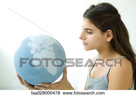 Teenage girl holding globe, side view, portrait View Large Photo Image Stock Photo - Teenage girl holding globe, side view, portrait. Fotosearch