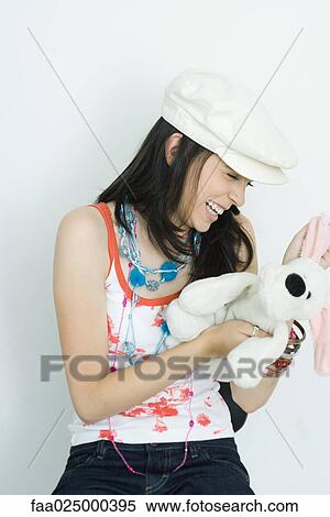 Teenage girl holding stuffed toy, laughing View Large Photo Image Stock Photography - Teenage girl holding stuffed toy, laughing. Fotosearch