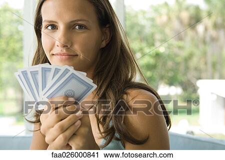 Teenage girl holding up cards, smiling at camera, close-up View Large Photo Image Stock Image - Teenage girl holding up cards, smiling at camera, close-up. Fotosearch