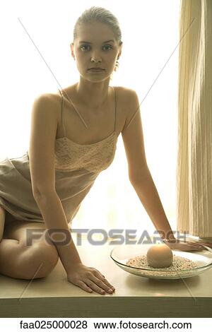 Teenage girl in slip sitting next to candle, looking at camera, backlit View Large Photo Image Stock Photo - Teenage girl in slip sitting next to candle, looking at camera, backlit. Fotosearch