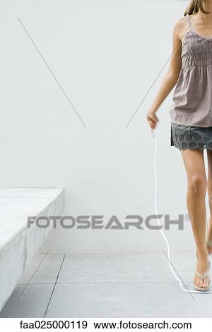Teenage girl jumping rope, cropped view View Large Photo Image Stock Photo - Teenage girl jumping rope, cropped view. Fotosearch