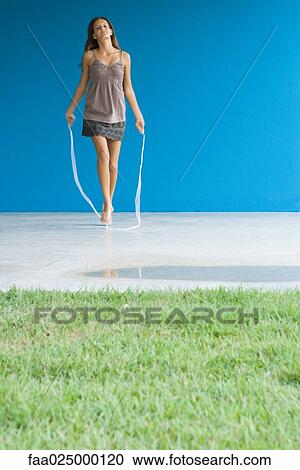 Teenage girl jumping rope, full length View Large Photo Image Stock Image - Teenage girl jumping rope, full length. Fotosearch