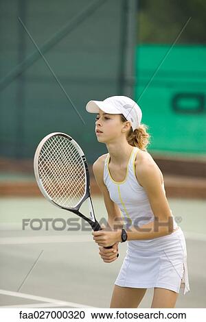 Teenage girl playing tennis, looking away View Large Photo Image Stock Image - Teenage girl playing tennis, looking away. Fotosearch