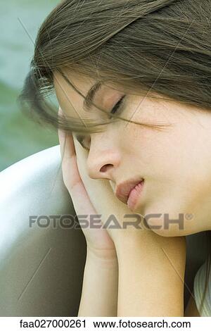 Teenage girl resting head on clasped hands, eyes closed, close-up View Large Photo Image Stock Image - Teenage girl resting head on clasped hands, eyes closed, close-up. Fotosearch