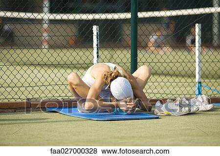 Teenage girl sitting on mat on the ground, bending over, stretching View Large Photo Image Stock Photo - Teenage girl sitting on mat on the ground, bending over, stretching. Fotosearch