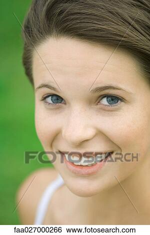 Teenage girl smiling at camera, portrait View Large Photo Image Stock Photograph - Teenage girl smiling at camera, portrait. Fotosearch