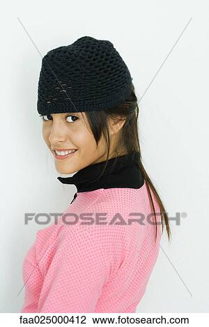 Teenage girl smiling over shoulder at camera, portrait View Large Photo Image Stock Image - Teenage girl smiling over shoulder at camera, portrait. Fotosearch