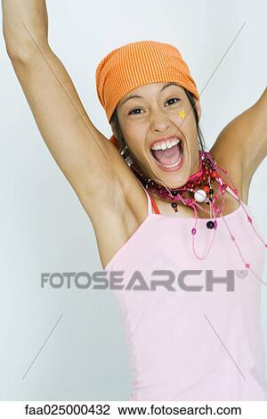 Teenage girl wearing bandana, smiling at camera with arms raised View Large Photo Image Stock Image - Teenage girl wearing bandana, smiling at camera with arms raised. Fotosearch