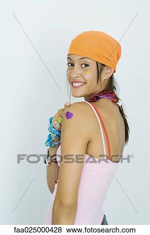 Teenage girl wearing bandana, smiling over shoulder at camera View Large Photo Image Stock Photo - Teenage girl wearing bandana, smiling over shoulder at camera. Fotosearch