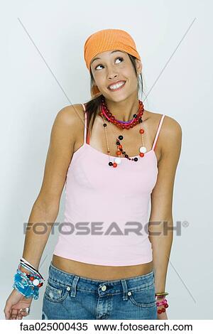 Teenage girl wearing bandana, smiling and looking up View Large Photo Image Stock Photography - Teenage girl wearing bandana, smiling and looking up. Fotosearch